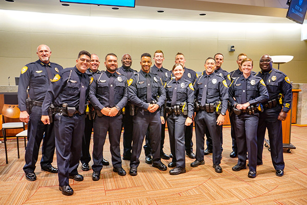 Multiple officers pose for a photo