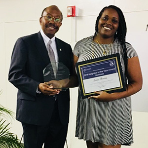 Representatives from the SouthWood Residential Community Association and Oak Knoll Estates accept their respective Neighborhood of the Year awards. Monet Moore accepts the Neighbor of the Year award on behalf of Leslie Harris from the Providence Neighborhood.