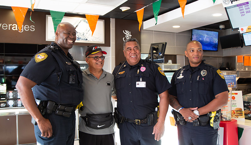 TPD officers meet with a member of the public at a Coffee with a Cop event.